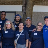 5 GVSU alumni smiling at camera